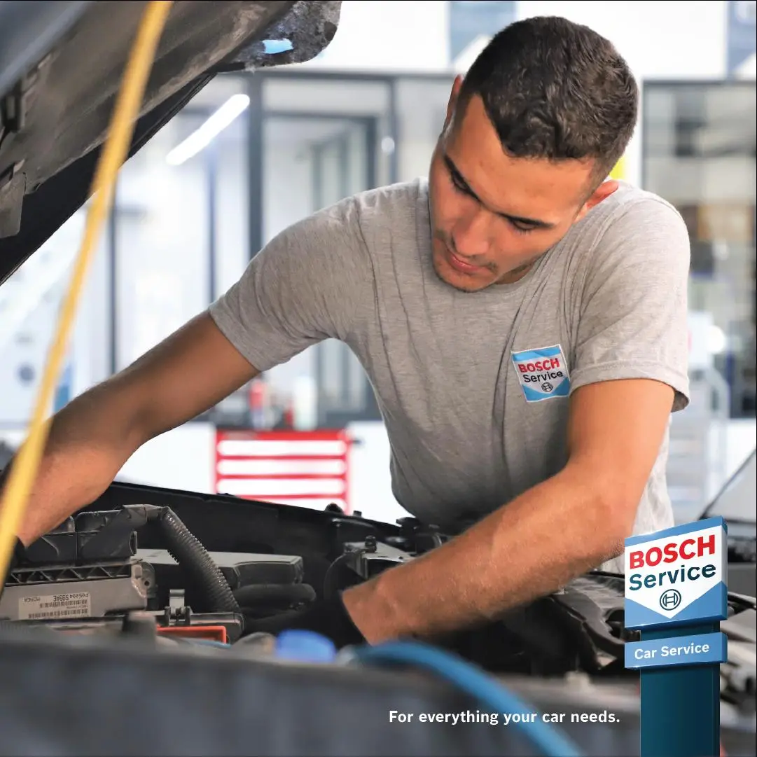 Bosch Car Service mechanic working in an engine bay Alan Aston Motor Engineers Evesham