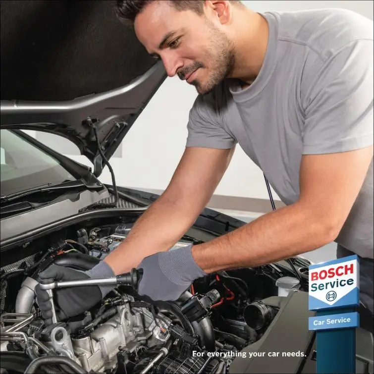 Mechanic repairing an engine in the workshop Alan Aston Motor Engineers Evesham