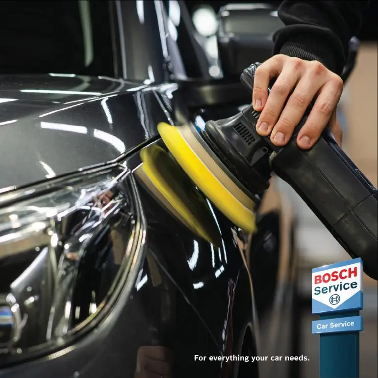 Car bodywork being machine polished Bosch Car Service Alan Aston Motor Engineers
