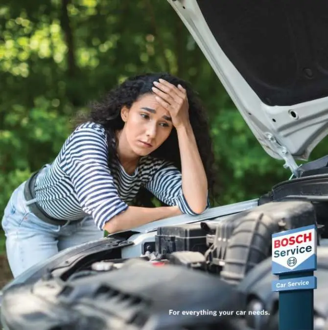 Driver checking an engine with the Bosch Car Service sign Alan Aston Motor Engineers Evesham