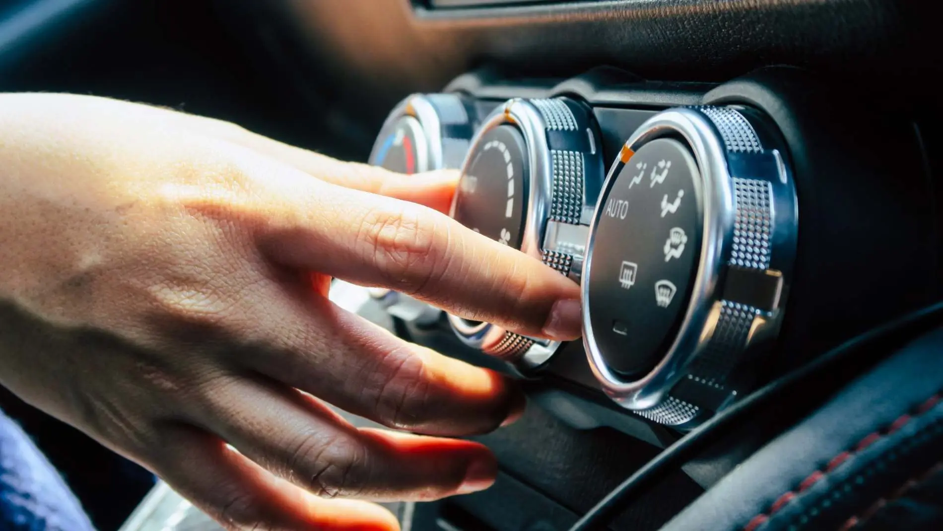 Driver adjusting car air conditioning controls Alan Aston Motor Engineers Evesham