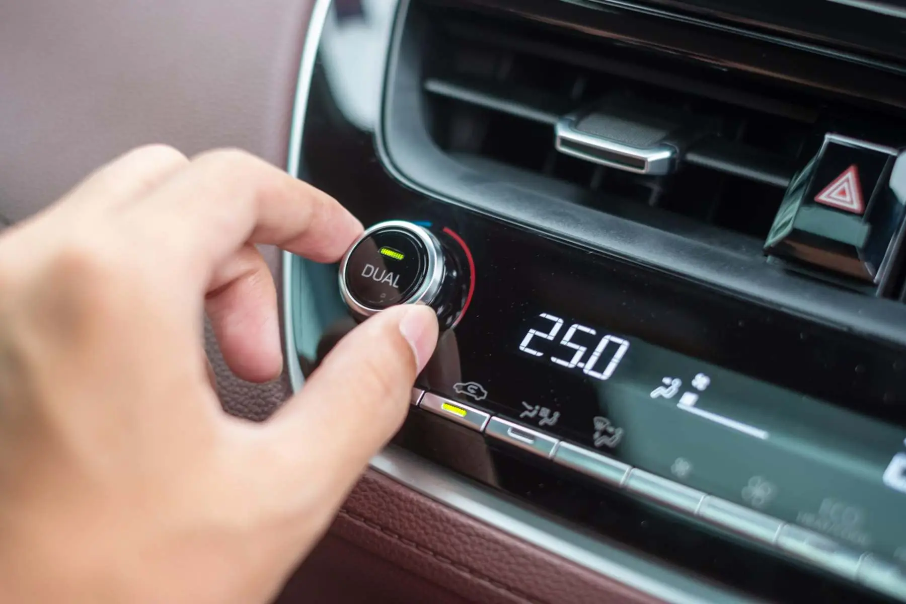 Driver adjusting the heater and temperature controls in a car Alan Aston Motor Engineers Evesham