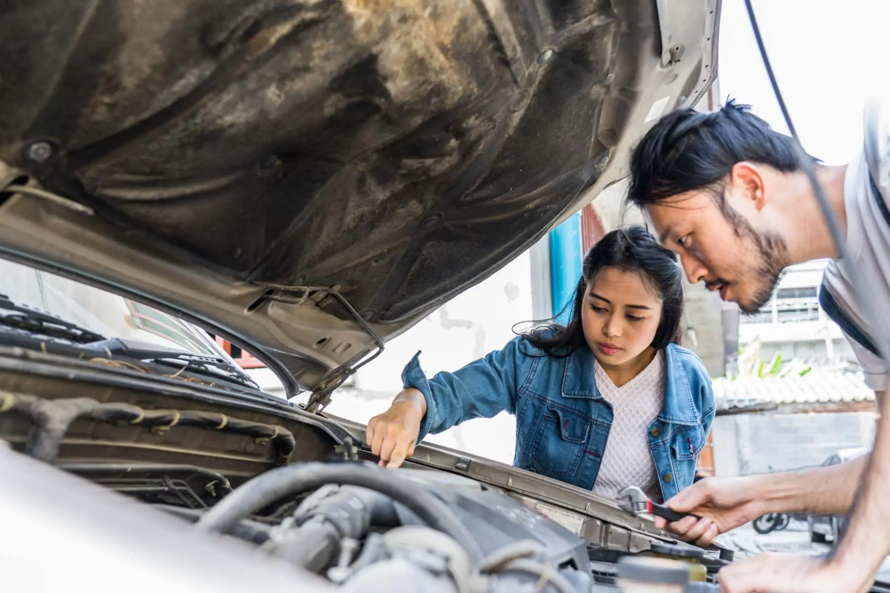 Mechanic and customer inspecting a car engine at Alan Aston Motor Engineers Evesham