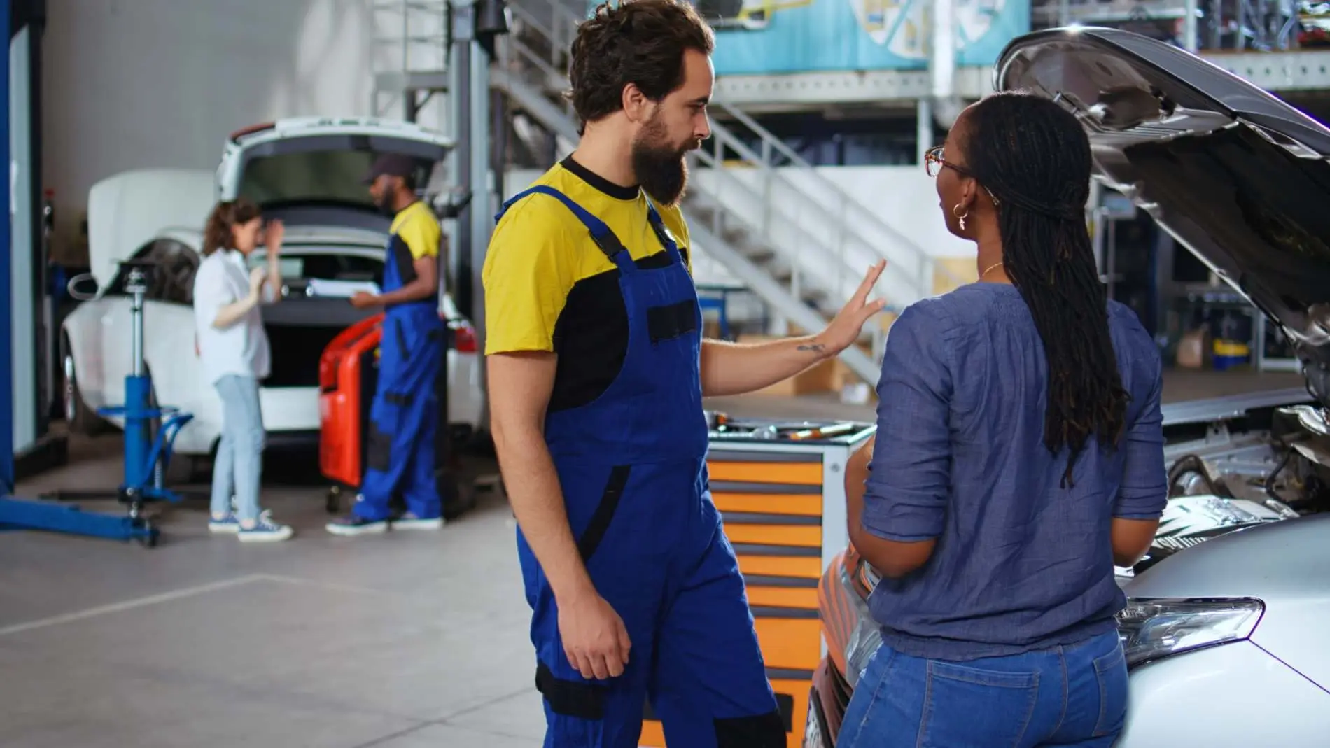 Mechanics discussing a car repair with a customer at Alan Aston Motor Engineers Evesham