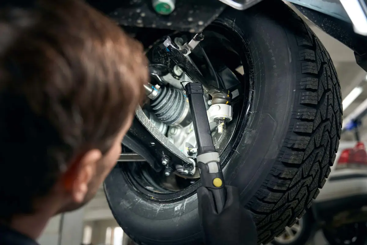 Mechanic checking boot collars and suspension in the workshop Alan Aston Motor Engineers Evesham