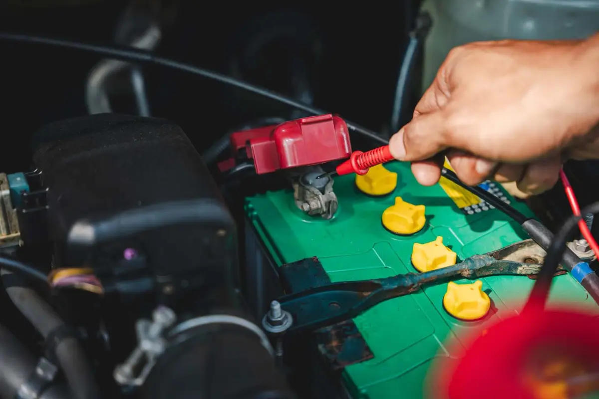 Mechanic testing a car battery Alan Aston Motor Engineers Evesham
