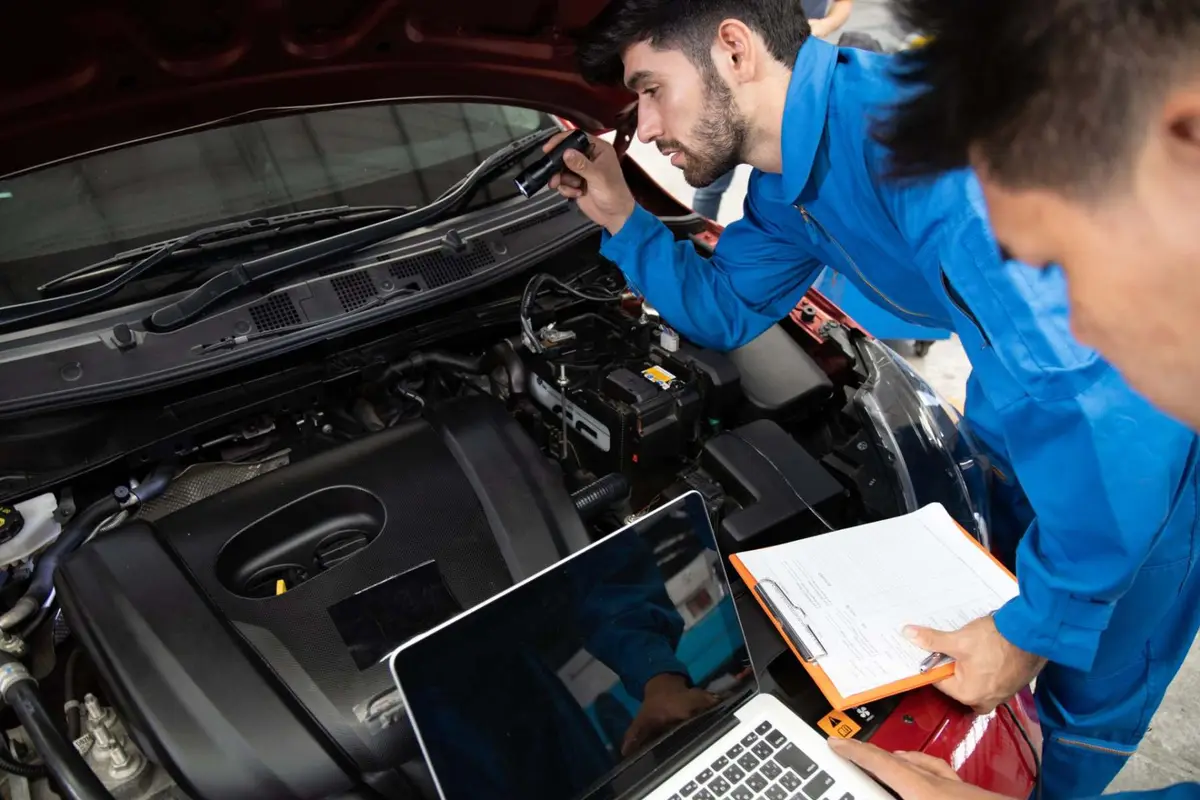 Mechanics running car diagnostics with a laptop Alan Aston Motor Engineers