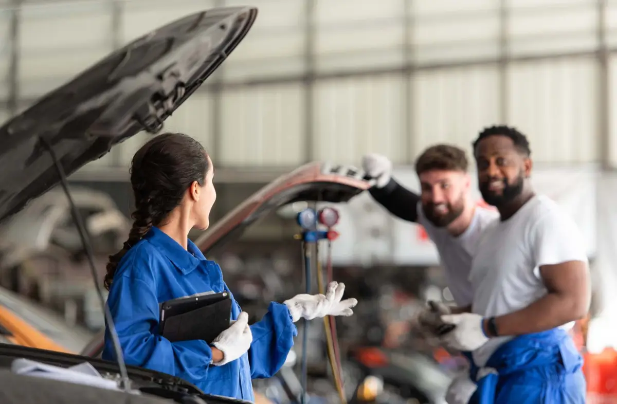 Mechanics inspecting a car during an MOT Alan Aston Motor Engineers Evesham